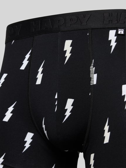 Männermodel trägt Trunks met bliksemschichtprint, Mix van katoen en elastaan, nauwsluitende pasvorm, elastische band, Set van 3 van Happy Socks, Nahaufnahme onderlichaam.