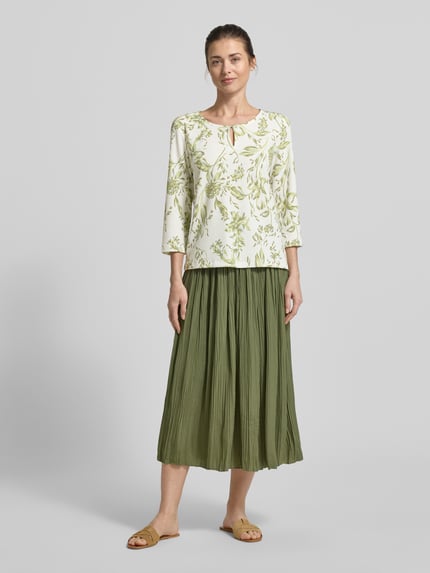 Vrouwenmodel draagt Regular Fit T-shirt met all-over motief van s.Oliver RED LABEL, ronde hals met druppelvormige hals, 3/4-mouw, crinkle materiaalverwerking, kleuren wit en groen, look: dames T-shirt, pasvorm: regular fit, voorkantaanzicht volledige lichaam