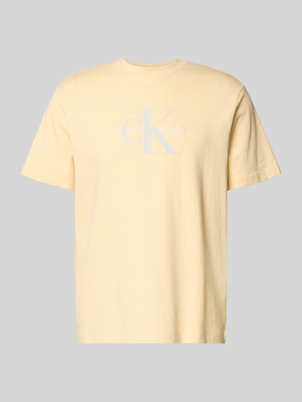 Productfoto, T-Shirt met Label-Print en ronde hals van Calvin Klein Jeans, regular fit van puur katoen in lichtgeel, ruglengte maat M 70 cm.
