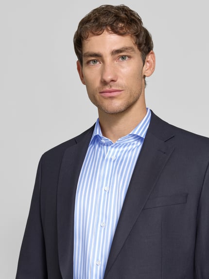 Männermodel trägt Regular Fit Business-Hemd mit Haifischkragen von Christian Berg Men, hellblau-weiß gestreift, Nahaufnahme Oberkörper. Baumwolle, langärmlig, moderner Look.