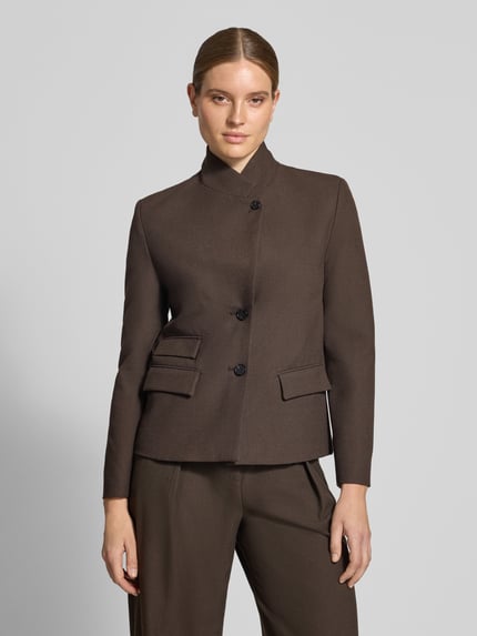 Frauenmodel trägt Regular Fit Blazer mit Stehkragen Modell 'LEO' von MANGO aus braunem Material-Mix mit Viskose, Nahaufnahme Oberkörper.