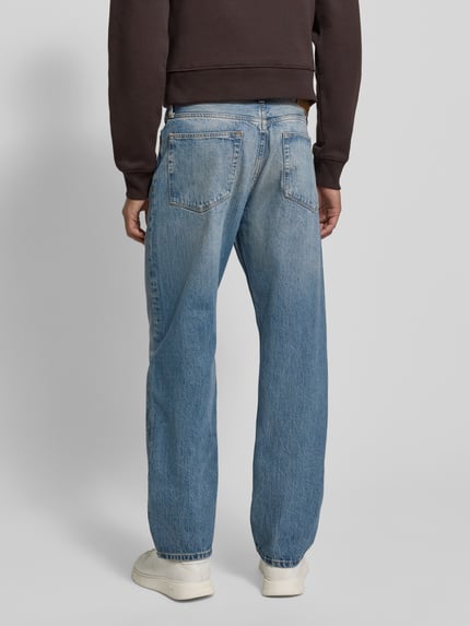Männermodel trägt Straight Leg Jeans aus reiner Baumwolle Modell 'DOVER' von Tommy Hilfiger in Denim, Optik: Unifarben, Ganzkörperansicht Rückansicht.