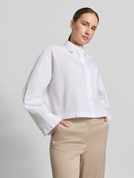 Frauenmodel trägt Hose mit Bügelfalten und Eingrifftaschen von More & More im Regular-Fit Material-Mix mit Viskose-Anteil, Nahaufnahme Oberkörper.