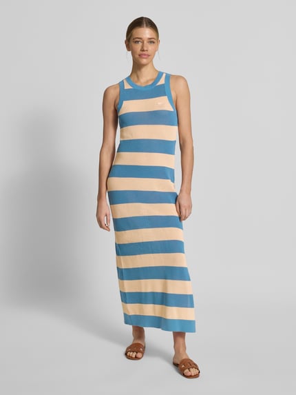 Vrouwenmodel draagt Enganliegendes Strickkleid aus reiner Baumwolle van Lacoste in blauw-beige gestreept, midi lengte, aansluitende fit, zonder mouwen, rond hals, logo-stiksel, split aan de zijkant, gebreide structuur, katoen, volledige frontale lichaamsaanzicht.