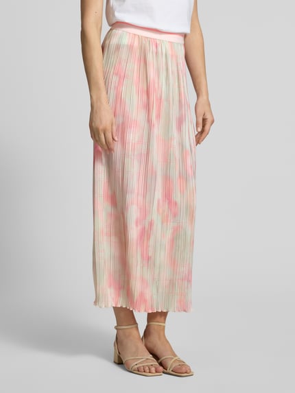 Frauenmodel trägt Ausgestellter Midi-Rock mit Plissees von Marc Cain, Allover-Muster in Rosa und Hellbeige, elastischer Bund, Ganzkörperansicht von vorne.