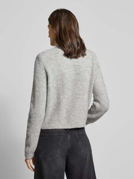 Frauenmodel trägt Strickjacke mit Knopfleiste von Rich & Royal in Grau mit gerippten Abschlüssen, lockerer Schnitt, Detailaufnahme Rückansicht.