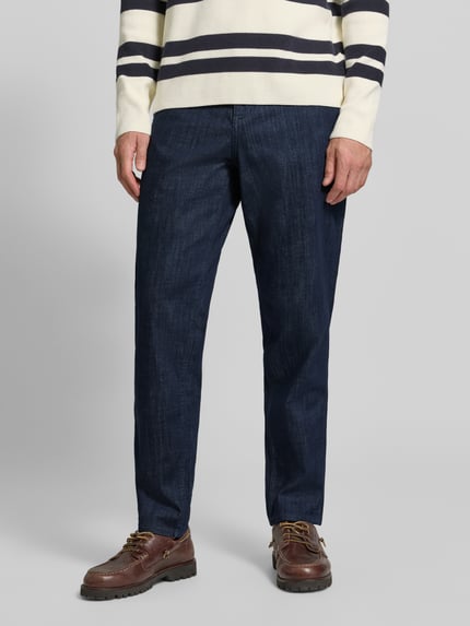 Męski model nosi Relaxed Fit Jeans aus Baumwoll-Mix Modell 'Tan' von Strellson, ciemnoniebieskie, prosty fason, wyraźna tekstura, całkowity widok z przodu. Kontext: Herren Relaxed Fit Jeans von Strellson