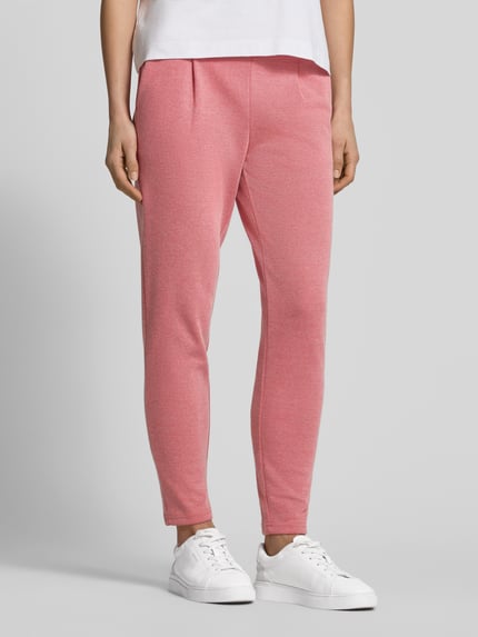 Frauenmodel trägt Slim Fit Stoffhose mit elastischem Bund Modell 'Kate' von ICHI, in Rosa, aus Baumwoll-Mix, Nahaufnahme Oberkörper. Paspeltaschen, schmale Passform, glatte Textur.