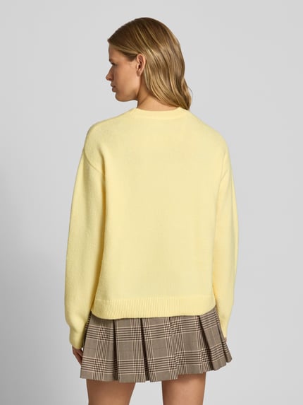 Vrouwenmodel draagt lichtgele Regular Fit Pullover met wol-aandeel model 'ALLY' van PIECES, dames pullover, volledige achteraanzicht.