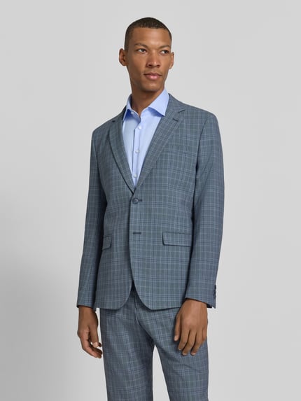 Männermodel trägt Slim Fit Sakko mit Brustleistentasche van Selected in gemêleerde look met fijn geweven motief, reverskraag, 2-knoopsluiting, borstzak, strookzakken, binnenzak; Ganzkörperansicht von vorne.