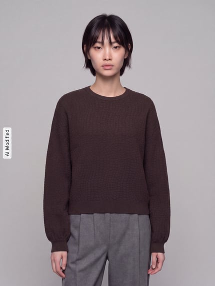 Frauenmodel trägt dunkelbraunen Regular Fit Pullover aus Viskose-Mix Modell 'NANCY' von VERO MODA, dezente Kachelstruktur, Ganzkörperansicht von vorne, KI-modifiziertes Bild.