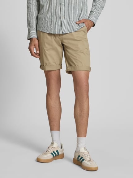Männermodel trägt Shorts mit Gürtel Modell 'MIKE' von Redefined Rebel in Beige, Regular Fit, Eingriff- und Gesäßtaschen, Nahaufnahme Unterkörper.