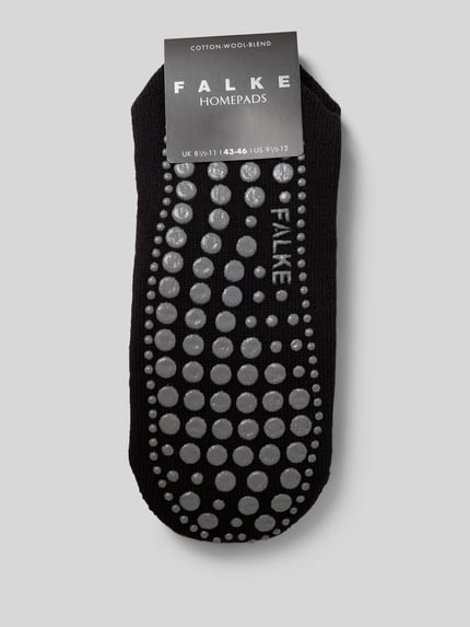 Produktfoto, Socken mit geripptem Abschluss von Falke aus Baumwoll-Woll-Mix mit Stretch-Anteil, Anti-Rutsch-Besatz, körpernaher Schnitt, schwarze Farbe, feine Struktur, kreisförmige graue Noppen
