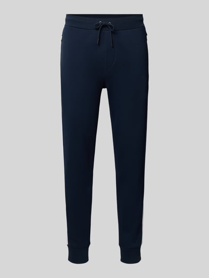 Produktfoto, Sweatpants mit elastischem Bund von Polo Ralph Lauren aus Baumwoll-Mix in Dunkelblau, lockerer Schnitt, Tunnelzug, Reißverschlusstaschen, Gesäßtasche, Innenbeinlänge 75 cm bei Größe M