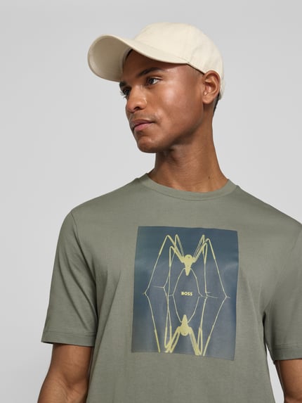 Męski model nosi Regular Fit T-Shirt aus reiner Baumwolle Modell 'TE_CREATURE' von BOSS Orange, jednokolorowy, nadruk z motywem, okrągły dekolt, krótki rękaw, dżersej, bawełna, półzbliżenie na górną część ciała.