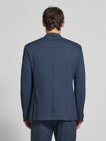 Männermodel trägt Slim Fit 2-Knopf-Sakko mit Pattentaschen von bugatti in Dunkelblau, Material-Mix mit Stretch-Anteil, Ganzkörperansicht Rückansicht.