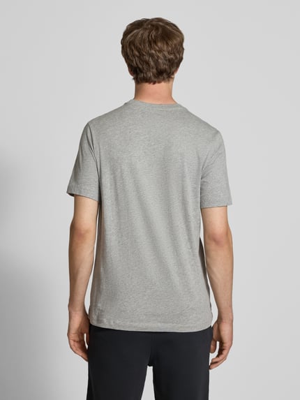 Männermodel trägt T-Shirt mit Label-Stitching von Nike aus Reine Baumwolle, Regular-Fit, Rundhalsausschnitt, Rückenlänge 73 cm, Ganzkörperansicht Rückansicht.