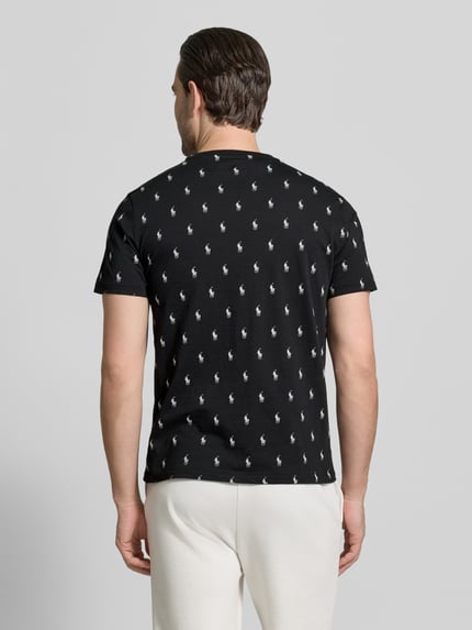 Männermodel trägt Regular Fit Pyjama-Oberteil aus reiner Baumwolle Modell 'CREW-SLEEP-TOP' von Polo Ralph Lauren Underwear mit Polo-Pony-Muster, schwarz mit weißen Details, kurzarm, Crew Neck, Ganzkörperansicht Rückansicht.