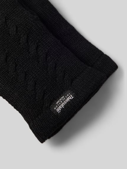 Produktfoto, Handschuhe aus reiner Wolle mit Label-Detail von EEM, schwarzer Zopfmuster-Strick, gerippter Abschluss, strukturierte Oberfläche.