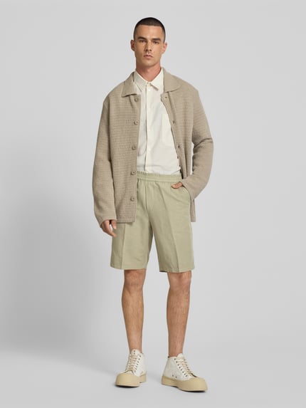 Männermodel trägt Straight Fit Shorts aus linnenmix van Filippa K, heren short met persplooien, gulp, achterzak, elastische band, ganzkörperansicht von vorne.