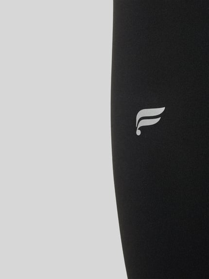 Produktfoto, schwarze Slim Fit Leggings mit Logo-Print von Fabletics aus elastischem Material-Mix, glatte Textur, knöchellang