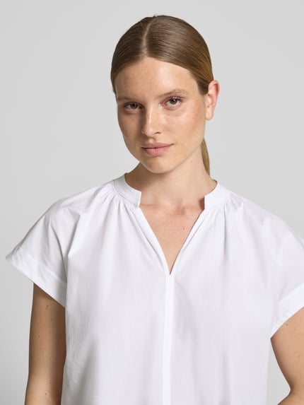 Frauenmodel trägt Blusenshirt mit Tunikakragen Modell 'Firu' von OPUS, Reine Baumwolle, Straight Fit, Weiß, Nahaufnahme Oberkörper.