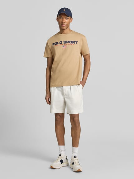 Męski model nosi Relaxed Fit T-Shirt aus reiner Baumwolle von Polo Ralph Lauren, efekt: jednolity kolor, krój relaxed fit, aplikacja: nadruk z logo, okrągły dekolt, rękaw: krótki rękaw, materiał: bawełna; całopostaciowy widok z przodu.