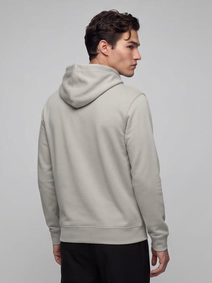 Männermodel trägt Regular Fit Hoodie mit Logo-Patch Modell 'Wetalk' von BOSS Orange in Beige, unifarben, Jersey, Ganzkörperansicht Rückansicht.