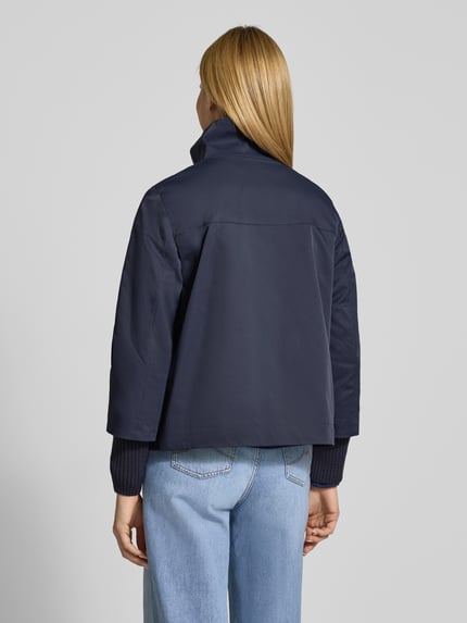 Frauenmodel trägt Jacke mit Stehkragen und Pattentaschen von Christian Berg Woman Selection in Dunkelblau, glatte Textur, Ganzkörperansicht Rückansicht. Regular Fit, Rückenlänge 60 cm, Schulterbreite 40 cm, Brustweite 46 cm, Ärmellänge 67 cm.