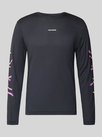 Produktfoto, Funktionsshirt mit Logo Modell 'Kout' von Salomon, czarny, kolorowe nadruki na rękawach, krój regular fit, bluzka z długim rękawem, okrągły dekolt, długość tyłu w rozmiarze M: 70 cm