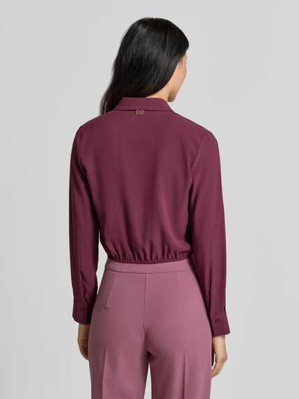 Vrouwenmodel draagt Blusenshirt met Umlegekragen van Rinascimento in effen bordeauxrood, lange mouwen, rechte fit, ruglengte maat S 47 cm, mouwlengte 59 cm, productopname, volledig van achteren