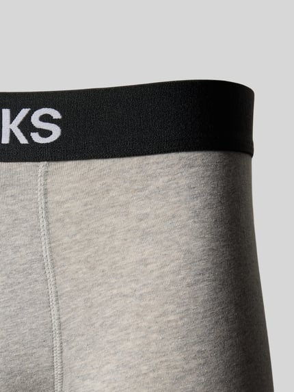 Produktfoto, Trunks mit Logo und elastischem Bund im 2er-Pack von Snocks aus Baumwoll-Elasthan-Mix in Grau mit schwarzem Bund, körpernahe Passform, dezente Textur.