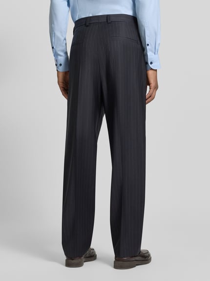 Männermodel trägt Regular Fit Bundfaltenhose aus Wolle von HUGO mit Nadelstreifen, Webware, Bundfalte, Bügelfalten, Ganzkörperansicht Rückansicht
