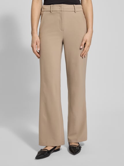 Frauenmodel trägt Stoffhose mit Gesäßtaschen Modell 'AMELIE' von Cambio, Material-Mix, gerader Schnitt, Bundfalten, Nahaufnahme Oberkörper.