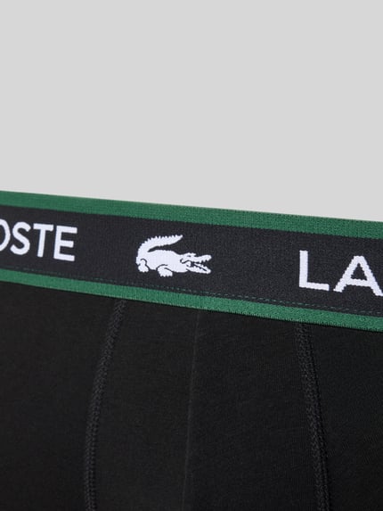 Produktfoto, schwarze Trunk aus Baumwoll-Mix im 3er-Pack von Lacoste für Herren, mit grünem Bund und weißem Logo, glatte Textur.
