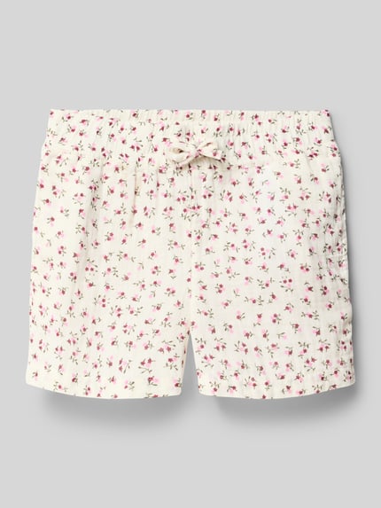 Produktfoto, Regular Fit Bermudas aus reiner Baumwolle Modell 'THYRA' von Only, Optik: Allover-Muster, Passform: Regular-Fit, florales Muster, Bundabschluss: elastisch, seitliche Eingrifftaschen, Material: reine Baumwolle, helle Grundfarbe mit rosa Blüten und grünen Details, feine Struktur.