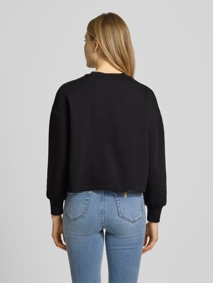 Frauenmodel trägt Sweatshirt mit Logo-Print und Rundhalsausschnitt von ARMANI EXCHANGE im Baumwoll-Mix mit Stretch-Anteil, Loose-Fit, Rückenansicht Ganzkörperansicht.