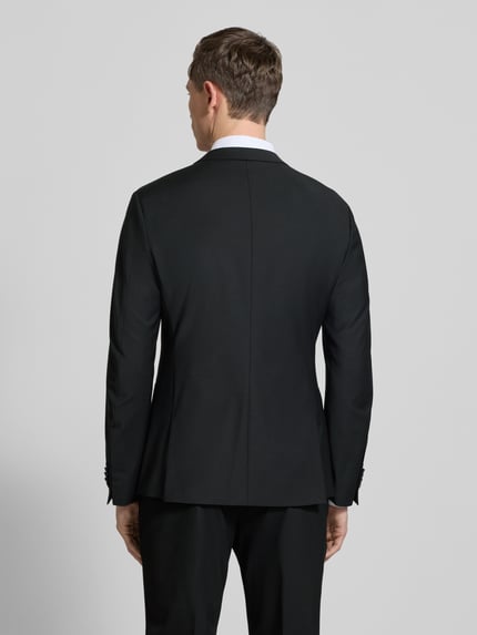 Männermodel trägt zwart Regular Fit Sakko met wolmix, model 'Irving' van Drykorn, reverskraag, paspelzakken, rugaanzicht, ruglengte 72 cm.