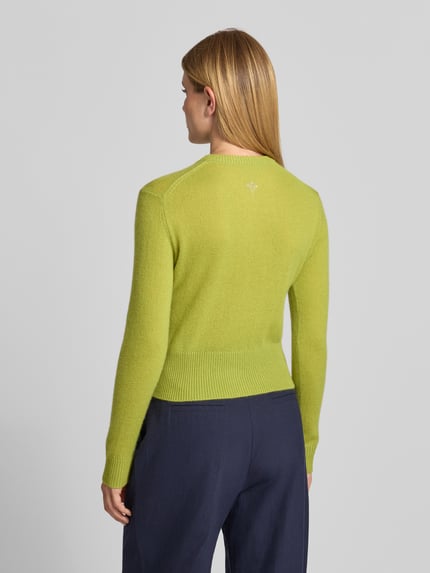 Frauenmodel trägt Strickjacke aus Kaschmir mit Rundhalsausschnitt Modell 'Karina' von JOOP!, Slim Fit, leuchtend grün, Rückansicht, Detailaufnahme, Damen Strickjacke, reine Kaschmir-Textur, Knopfleiste, Rückenlänge und Ärmellänge in Größe 36.