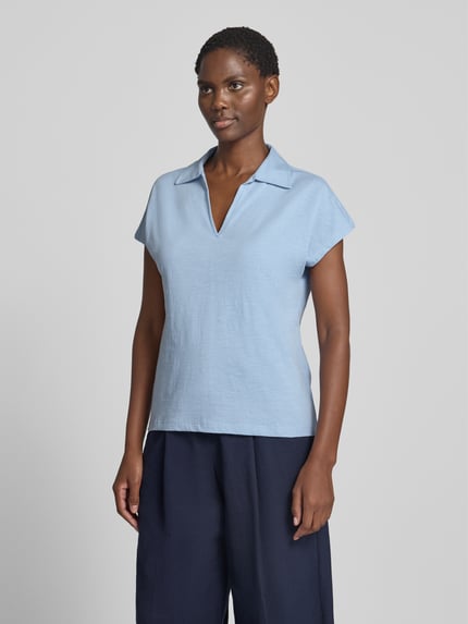 Frauenmodel trägt Regular Fit Poloshirt aus reiner Baumwolle von s.Oliver RED LABEL in Hellblau, glatte Textur, Ganzkörperansicht von vorne.