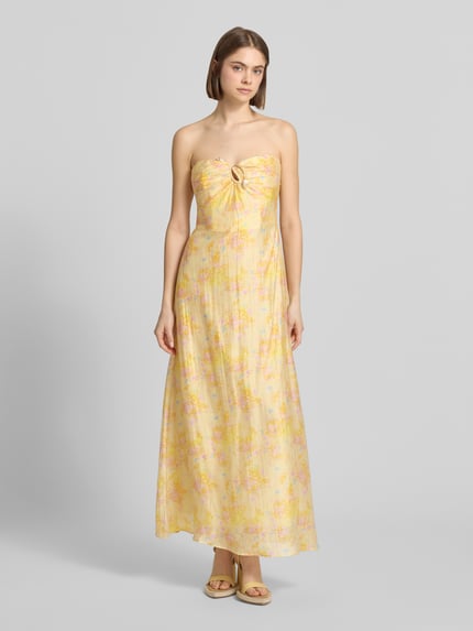 Frauenmodel trägt Maxikleid im Off-Shoulder-Look Modell 'AMINA' von Bardot, zartes Gelb mit floralen Mustern, Lyocell-Mix mit Ramie-Anteil, A-Linie, Rückenlänge 116 cm, Brustweite 36 cm, Ganzkörperansicht von vorne.