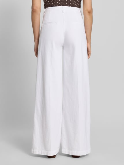 Frauenmodel trägt Hose mit Bügelfalten und Eingrifftaschen von SEDUCTIVE aus Leinen-Baumwoll-Mix in Weiß, Ganzkörperansicht Rückansicht.