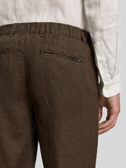 Mannenmodel draagt Leinenhose mit Eingrifftaschen Modell 'Pandrup' van Casual Friday, zuiver linnen, regular fit, steekzakken, kleur bruin, detailopname achterkant.