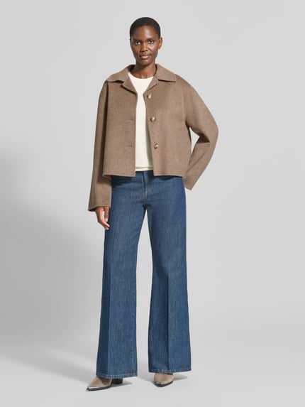 Frauenmodel trägt Regular Fit Jacke aus Woll-Mix von Jake*s Collection in Beige zu blauen Jeans, Ganzkörperansicht von vorne.