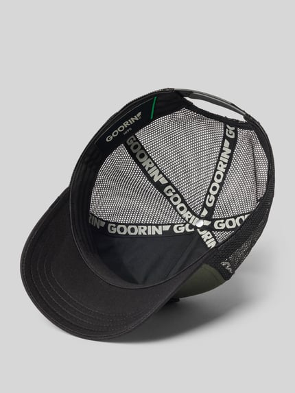 Produktfoto, Trucker Cap mit Stitching Modell 'Bad Boy' von GOORIN BROS., mieszanka materiałów z mieszanką bawełny, daszek wzmocniony, haft, regulowana długość, czarne i zielone elementy, tekstura siateczkowa z tyłu