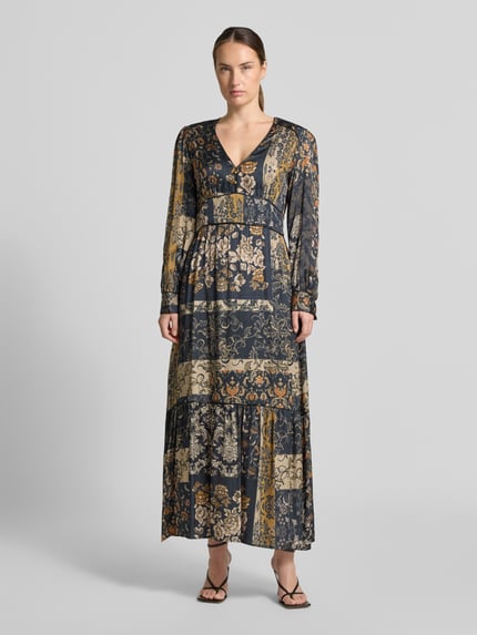 Frauenmodel trägt Maxikleid aus reiner Viskose von Liu Jo White, V-Ausschnitt mit Zierknöpfen, Ballonärmel, florales Muster, Ganzkörperansicht von vorne.