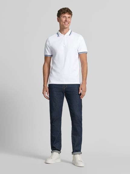Männermodel trägt Slim Fit Poloshirt mit Kontraststreifen und Reißverschluss von MCNEAL aus Baumwoll-Elasthan-Mix, Herren, Ganzkörperansicht von vorne. Rückenlänge bei Größe M: 73 cm.