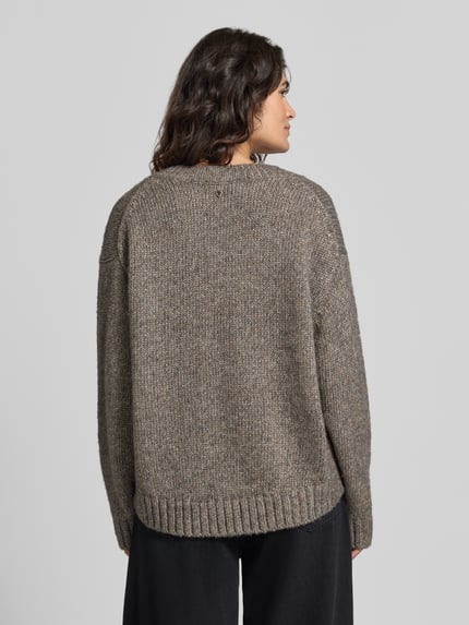Frauenmodel trägt Oversized Strickpullover mit Woll-Anteil Modell 'Welma' von MOS MOSH, melierte Optik, gerippte Abschlüsse, Rückenansicht.