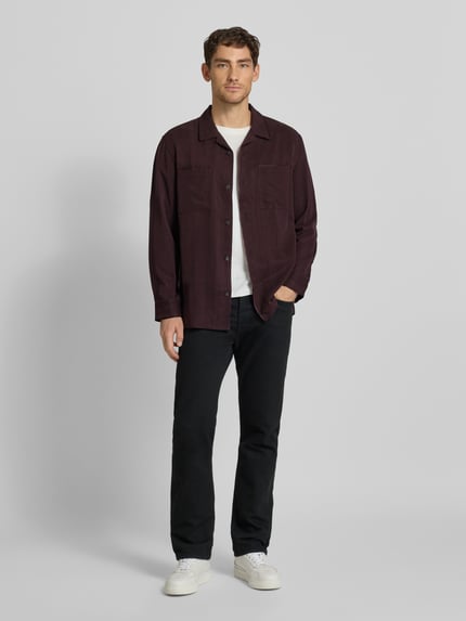 Männermodel trägt Hemdjacke mit Knopfleiste von CK Calvin Klein aus Lyocell in Dunkelrot, lockerer Schnitt, Ganzkörperansicht von vorne.