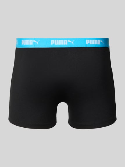Produktfoto, Trunks im 4er-Pack mit elastischem Logo-Bund von PUMA in Schwarz mit blauem Logo-Bund, Baumwoll-Mix mit Stretch-Anteil, Körpernaher-Schnitt